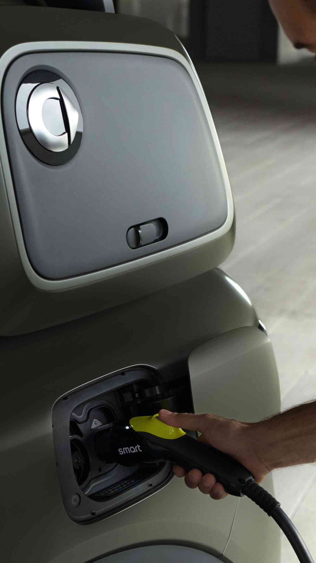 A man in a yellow shirt charging his smart #5.